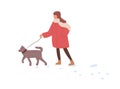 Child walking with dog in winter. Kid leading puppy on leash in cold weather with snow. Girl, pet owner strolling with