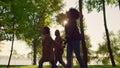 Child walking holding parents hands in green park. Happy family time outdoors Royalty Free Stock Photo