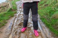 Child walking in mud with rubber boots