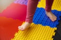 child walking on orthopedic feet massage floor mat