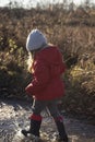 Child walking in puddle with wellies