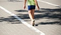 A child walks in shorts on the sidewalk in the summer in slow motion. Feet baby closeup