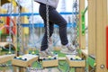 child walks on a suspended children& x27;s chain road on the playground Royalty Free Stock Photo