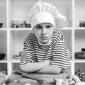 Child want to be a professional chef. Boy wearing chef hat and uniform. Cooking food concept