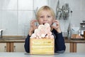 Child wants to eat the cake. Kid greedily looks at the cake