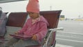 Child watching tablet at airport departure launge