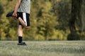 Child warming up before soccer practice stretching his leg