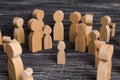 The child was lost in the crowd. A crowd of wooden figures of people surround a lost child. Lost kid Royalty Free Stock Photo