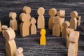 The child was lost in the crowd. A crowd of wooden figures of people surround a lost child. Lost, parents who have lost kid baby Royalty Free Stock Photo