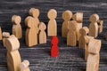 The child was lost in the crowd. A crowd of wooden figures of people surround a lost child. Lost kids Royalty Free Stock Photo