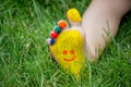 The child was lying on the green grass. Smile with paints on the legs and arms. Child having fun outdoors in the spring Royalty Free Stock Photo