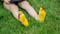 The child was lying on the green grass. Smile with paints on the legs and arms. Child having fun outdoors in the spring Royalty Free Stock Photo