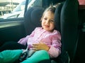 the child was seasick in the car. sad toddler sitting in a child seat