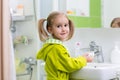 Child washes his hands at bathroom. Girl washing hands with soap Royalty Free Stock Photo