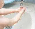 A child washes his hands with soap in the bathroom. The concept of hygiene and clean hands, infection, close-up, soundness,