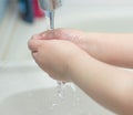 A child washes his hands with soap in the bathroom. The concept of hygiene and clean hands, infection, close-up, soundness