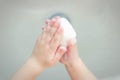 A child washes his hands with soap in the bathroom. The concept of hygiene and clean hands, infection, close-up