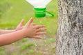 Child washes his hands on the street