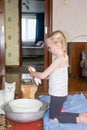 child washes a soft toy with soap in a basin Royalty Free Stock Photo