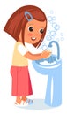 Child washing hand in sink with soap bubbles around