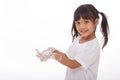 Child washing hands and showing soapy palms.