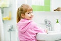 Child washing her face and hands in bathroom Royalty Free Stock Photo