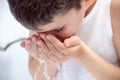 The child is washing his face. Royalty Free Stock Photo