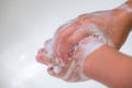 A child washing his hands with soap in bathroom sink Royalty Free Stock Photo