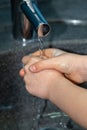 Child washing his hands to prevent illness Royalty Free Stock Photo