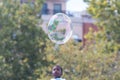 Child Watches Large Egg Shaped Bubble Float By At Festival