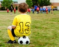 Child watching soccer game Royalty Free Stock Photo
