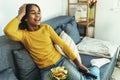 Child watching television sitting on the sofa Royalty Free Stock Photo