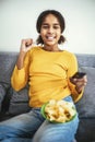 Child watching television sitting on the sofa. Royalty Free Stock Photo