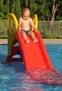 Child on water slide Royalty Free Stock Photo