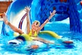 Child on water slide at aquapark. Royalty Free Stock Photo