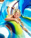 Child on water slide at aquapark. Royalty Free Stock Photo