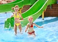 Child on water slide at aquapark. Royalty Free Stock Photo