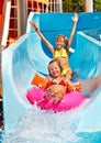 Child on water slide at aquapark.