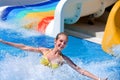 Child on water slide at aquapark. Royalty Free Stock Photo