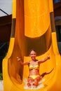 Child on water slide at aquapark shows thumbs up. Royalty Free Stock Photo