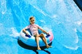 Child on water slide at aquapark.