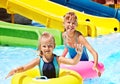 Child on water slide at aquapark. Royalty Free Stock Photo