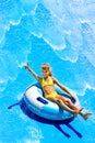 Child on water slide at aquapark. Royalty Free Stock Photo