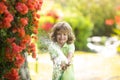 Child is watering the plant outside the house, concept of plant growing learning activity for kids and children