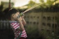 Child is watering to plant in pot at home Royalty Free Stock Photo