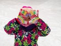 Child wearing colorful clothes pink hat plays snow. Royalty Free Stock Photo