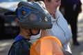 Child wearing a dinosaur mask