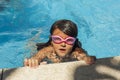 Child wearing goggles, breathing while swimming in the pool. Royalty Free Stock Photo