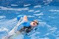 Child wearing goggles swimming freestyle in the pool Royalty Free Stock Photo