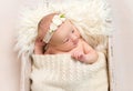 Child wearing a hairband in baby basket, closeup